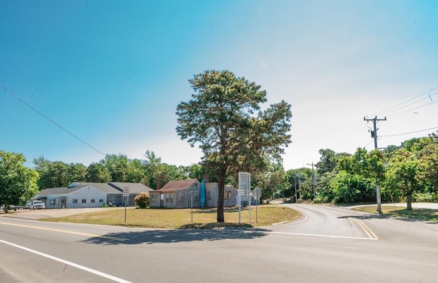 71 Main St, Dennis, MA 02639 - view of asphalt road with traffic signs and view of scattered trees