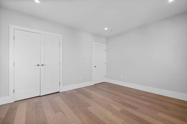 39 Bonner Ave Unit 39, Medford, MA 02155 - unfurnished bedroom with wood finished floors, recessed lighting, baseboards, and a closet