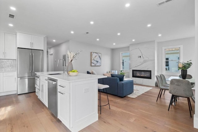 39 Bonner Ave Unit 39, Medford, MA 02155 - kitchen with stainless steel appliances, a sink, recessed lighting, light wood-style floors, and open floor plan