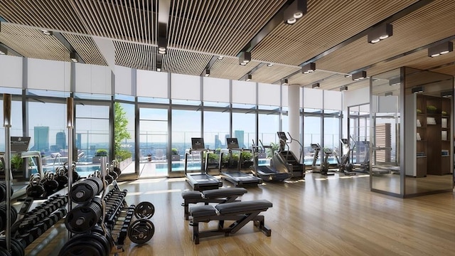 682 Atlantic Ave Unit 37J, Boston, MA 02111 - exercise room featuring wood finished floors, expansive windows, a view of city, and a towering ceiling