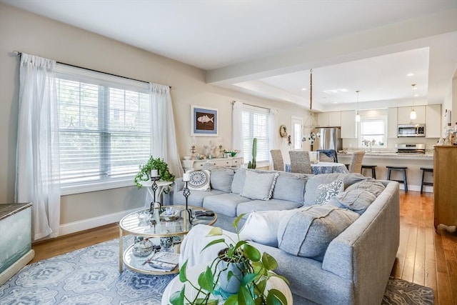 637 Gifford St Unit 4A, Falmouth, MA 02540 - living room featuring wood finished floors, a tray ceiling, and recessed lighting