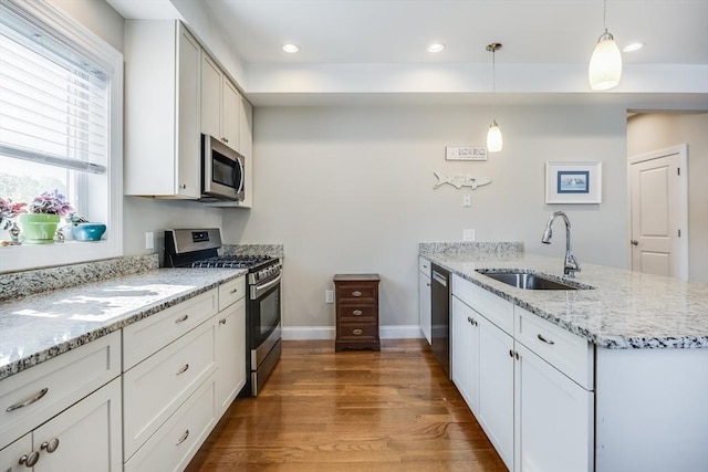 637 Gifford St Unit 4A, Falmouth, MA 02540 - kitchen featuring stainless steel appliances, a peninsula, wood finished floors, white cabinets, and recessed lighting