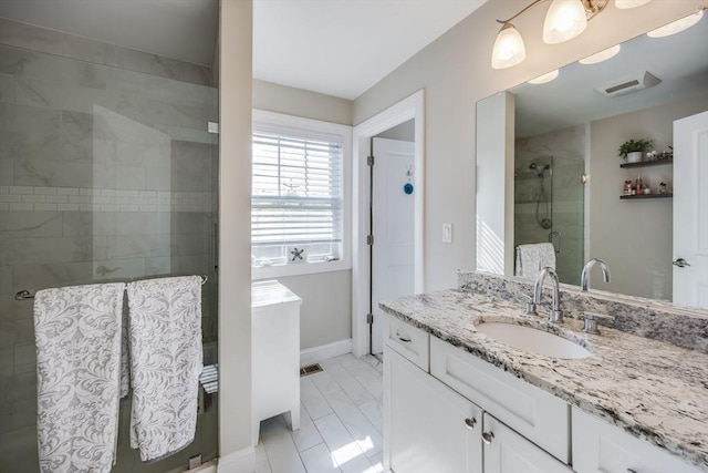 637 Gifford St Unit 4A, Falmouth, MA 02540 - bathroom featuring vanity, a tile shower, and marble look tile flooring
