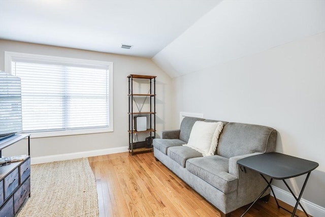 637 Gifford St Unit 4A, Falmouth, MA 02540 - sitting room with light wood-style flooring and vaulted ceiling