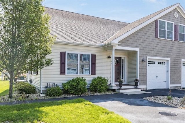 637 Gifford St Unit 4A, Falmouth, MA 02540 - view of front of property featuring driveway, a shingled roof, and an attached garage