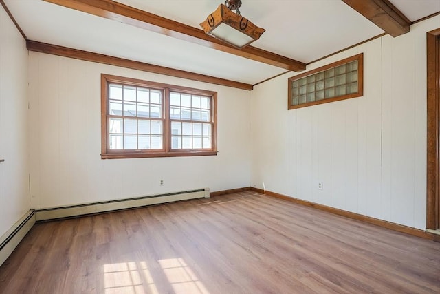 spare room with baseboards, beamed ceiling, a baseboard heating unit, and wood finished floors