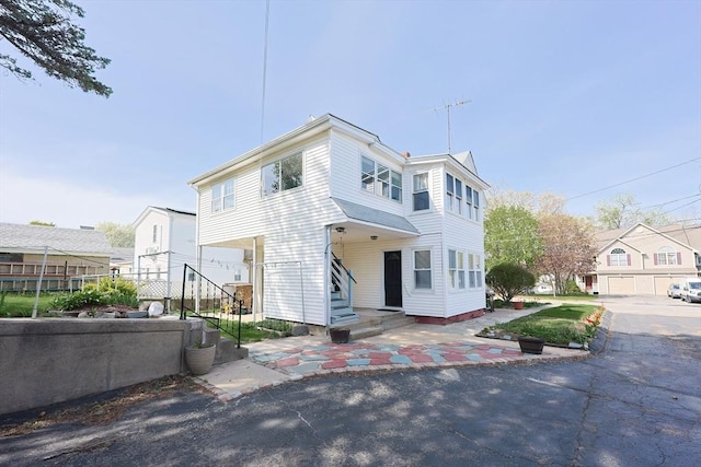 view of front of house featuring a patio area and fence