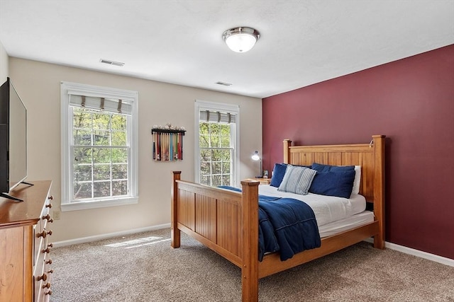 bedroom with carpet flooring, baseboards, and visible vents