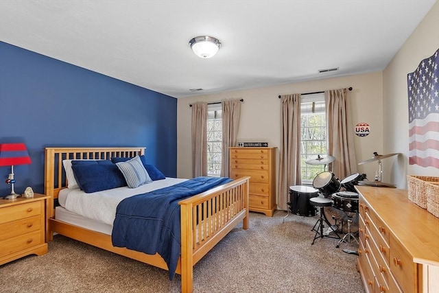 bedroom with light colored carpet and visible vents