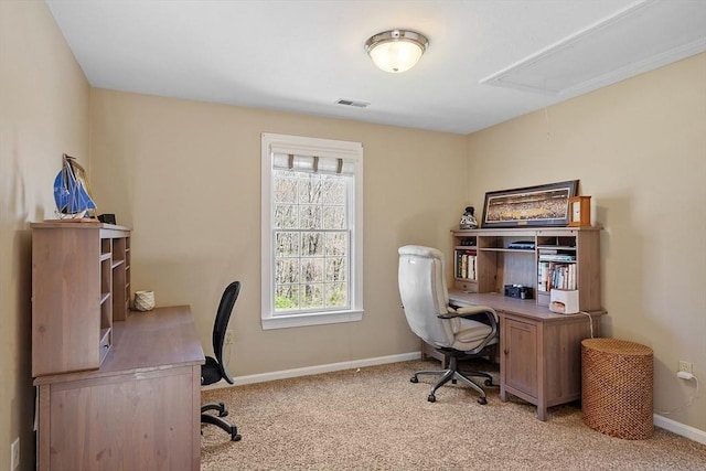 office space with baseboards, visible vents, light carpet, and attic access
