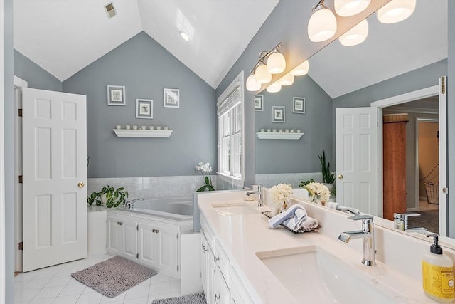 full bathroom with visible vents, a sink, lofted ceiling, and tile patterned floors