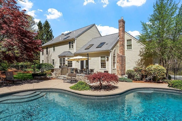 outdoor pool with a patio and fence