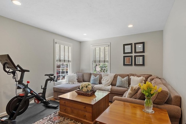 living area with baseboards and recessed lighting