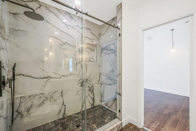 bathroom featuring a shower with shower door and hardwood / wood-style floors