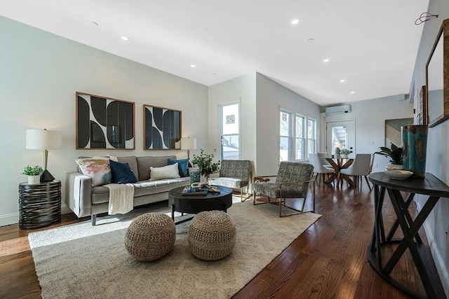 living room featuring a wall unit AC and dark hardwood / wood-style floors