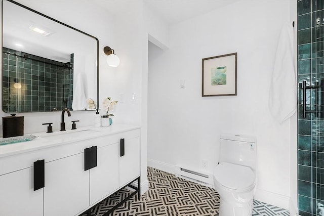 bathroom with vanity, a tile shower, toilet, and baseboard heating