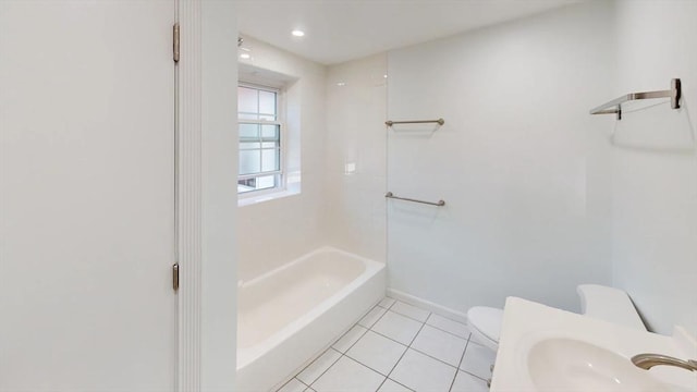 bathroom featuring tile patterned floors, toilet, baseboards, and a sink