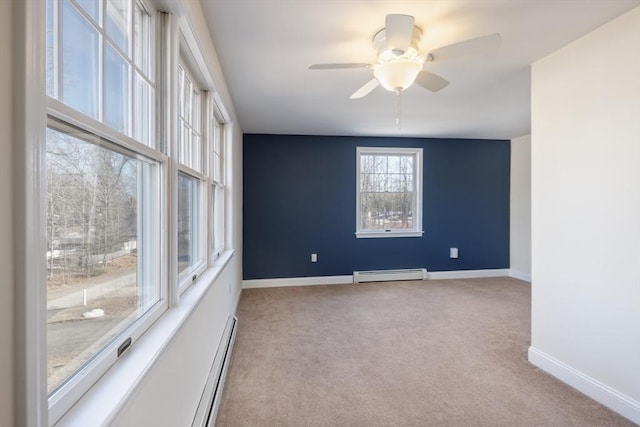 carpeted spare room featuring ceiling fan, baseboards, and a baseboard radiator