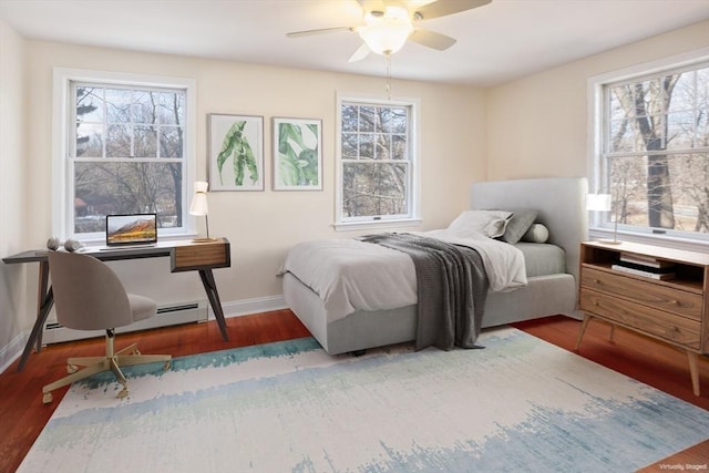 bedroom featuring multiple windows and wood finished floors