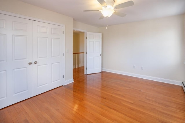 unfurnished bedroom featuring light wood finished floors, baseboards, a closet, and a ceiling fan