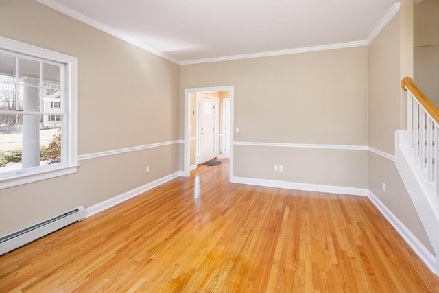 unfurnished room with baseboards, baseboard heating, light wood-style flooring, and crown molding