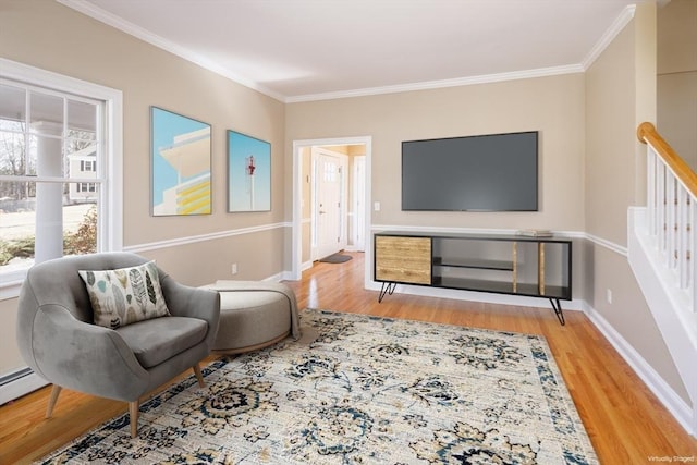 sitting room featuring ornamental molding, stairs, baseboards, and wood finished floors