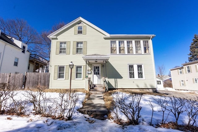 view of front of home featuring fence