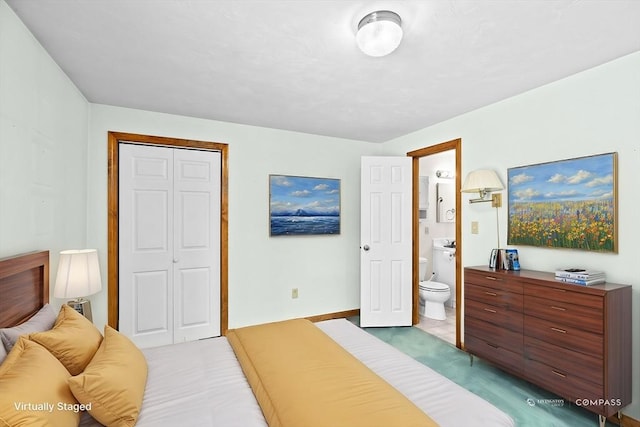 tiled bedroom with ensuite bathroom and a closet