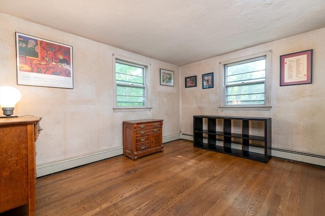 397 Elm St, Braintree, MA 02184 - empty room with a baseboard heating unit, wood finished floors, and baseboards