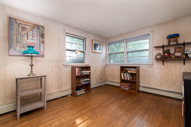 397 Elm St, Braintree, MA 02184 - living area with a baseboard radiator, wood finished floors, and wallpapered walls