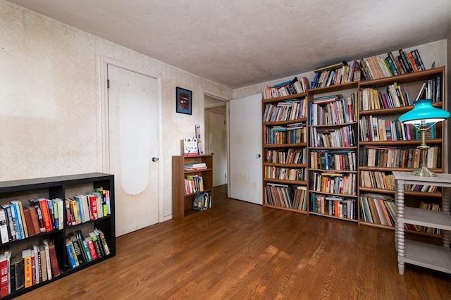 397 Elm St, Braintree, MA 02184 - living area featuring wood finished floors, bookshelves, and a textured wall