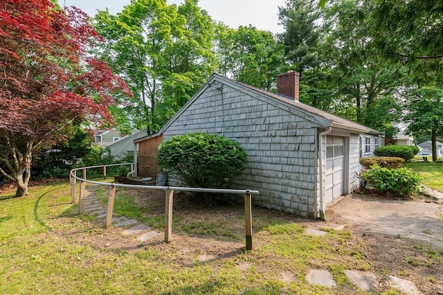 397 Elm St, Braintree, MA 02184 - view of side of home featuring a chimney and a detached garage
