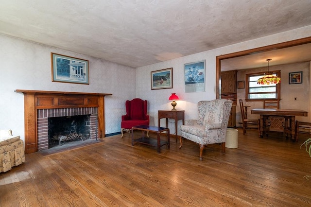 397 Elm St, Braintree, MA 02184 - sitting room featuring wood finished floors and a brick fireplace