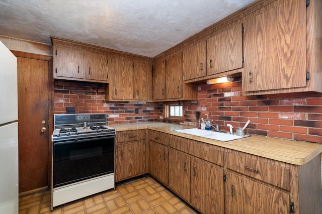 397 Elm St, Braintree, MA 02184 - kitchen with white gas stove, a sink, light countertops, and brown cabinetry