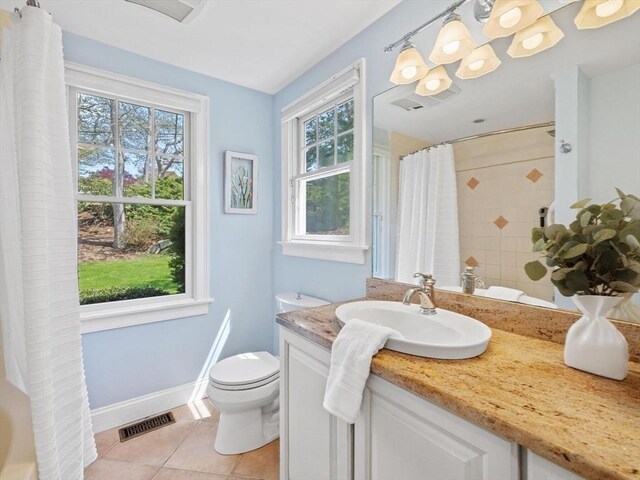 bathroom featuring tile patterned flooring, toilet, vanity, curtained shower, and baseboards
