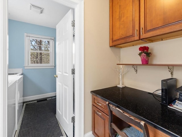 bathroom with washing machine and dryer, baseboards, and tile patterned flooring
