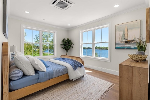 18 Franklin Unit 203, Salem, MA 01970 - bedroom featuring baseboards, crown molding, wood finished floors, recessed lighting, and a water view