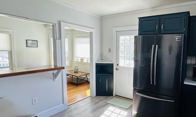 1 S Ave Unit 1, Hull, MA 02045 - kitchen with freestanding refrigerator, crown molding, light wood-style floors, blue cabinetry, and light countertops