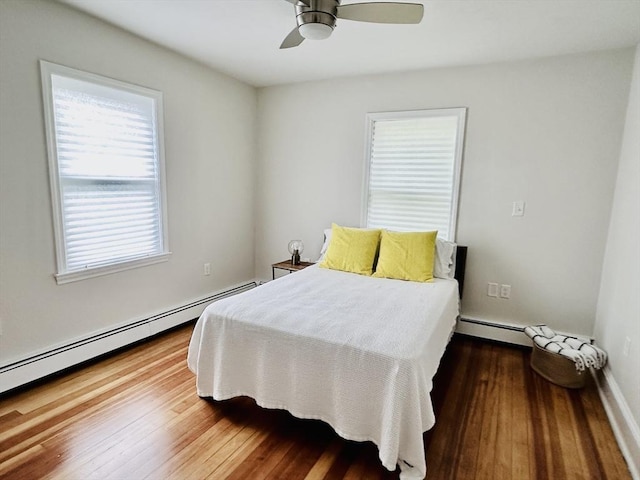 1 S Ave Unit 1, Hull, MA 02045 - bedroom featuring baseboard heating, wood finished floors, and a ceiling fan