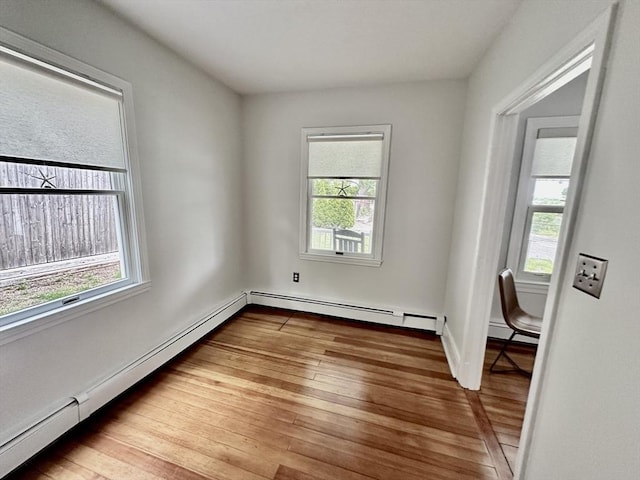 1 S Ave Unit 1, Hull, MA 02045 - empty room with plenty of natural light, hardwood / wood-style floors, a baseboard radiator, and baseboard heating