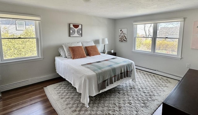 1 S Ave Unit 1, Hull, MA 02045 - bedroom with a baseboard heating unit, multiple windows, dark wood finished floors, and a textured ceiling