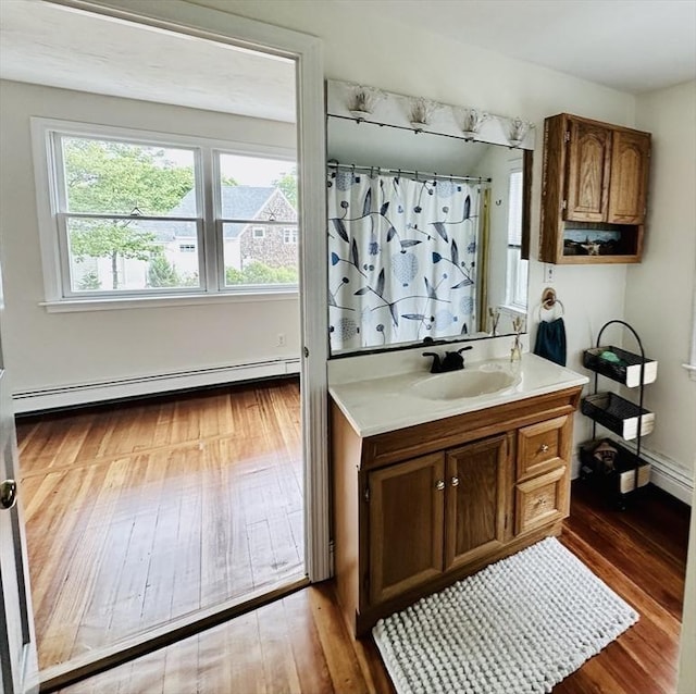 1 S Ave Unit 1, Hull, MA 02045 - bathroom featuring a baseboard heating unit, hardwood / wood-style floors, vanity, and a shower with curtain