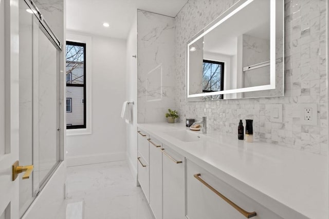 bathroom featuring vanity and a shower with door