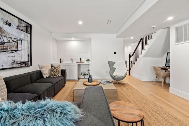 living room featuring sink and light wood-type flooring