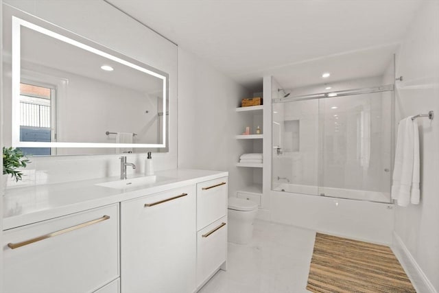 full bathroom featuring bath / shower combo with glass door, vanity, and toilet