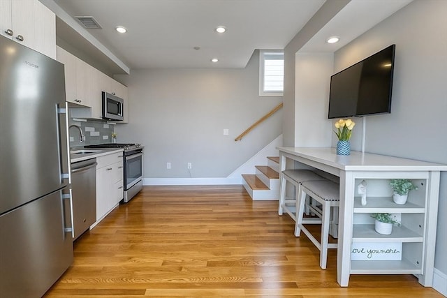 89 Prescott St Unit C, Boston, MA 02128 - kitchen with stainless steel appliances, light countertops, light wood-style floors, and recessed lighting