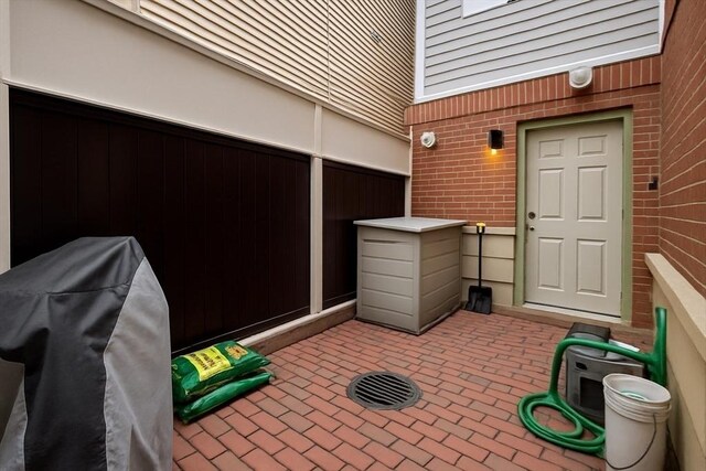 89 Prescott St Unit C, Boston, MA 02128 - property entrance featuring brick siding and a patio