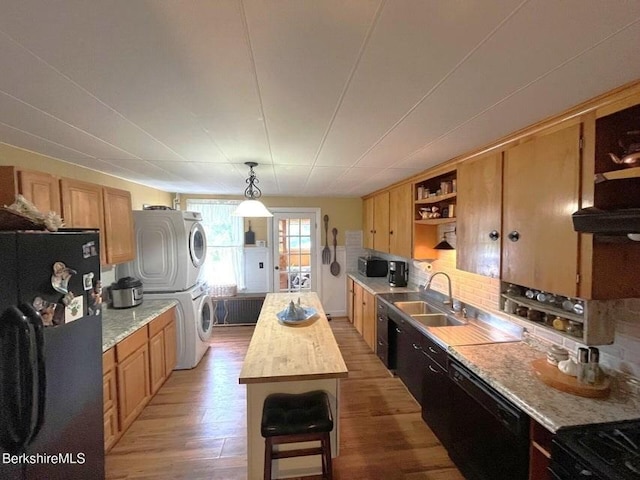 56-58 N Summer St, Adams, MA 01220 - kitchen featuring stacked washer / drying machine, black appliances, open shelves, light wood-style flooring, and tasteful backsplash