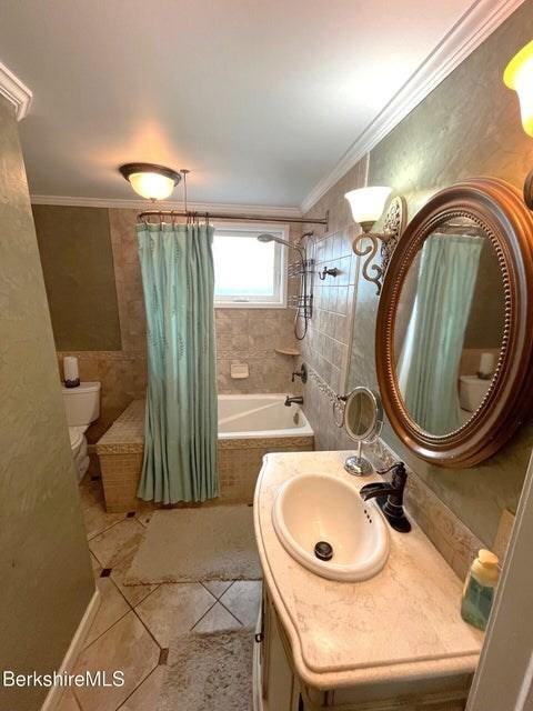 56-58 N Summer St, Adams, MA 01220 - full bathroom with tiled shower / bath, toilet, tile patterned flooring, vanity, and crown molding