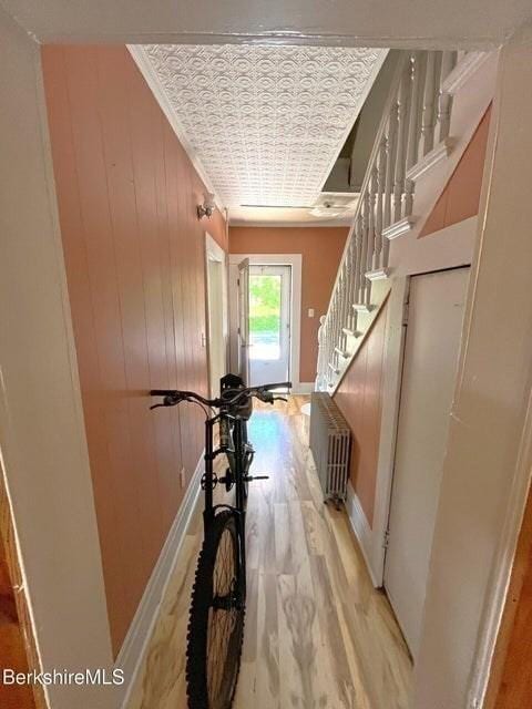 56-58 N Summer St, Adams, MA 01220 - hall with light wood-style flooring, stairway, baseboards, an ornate ceiling, and radiator heating unit